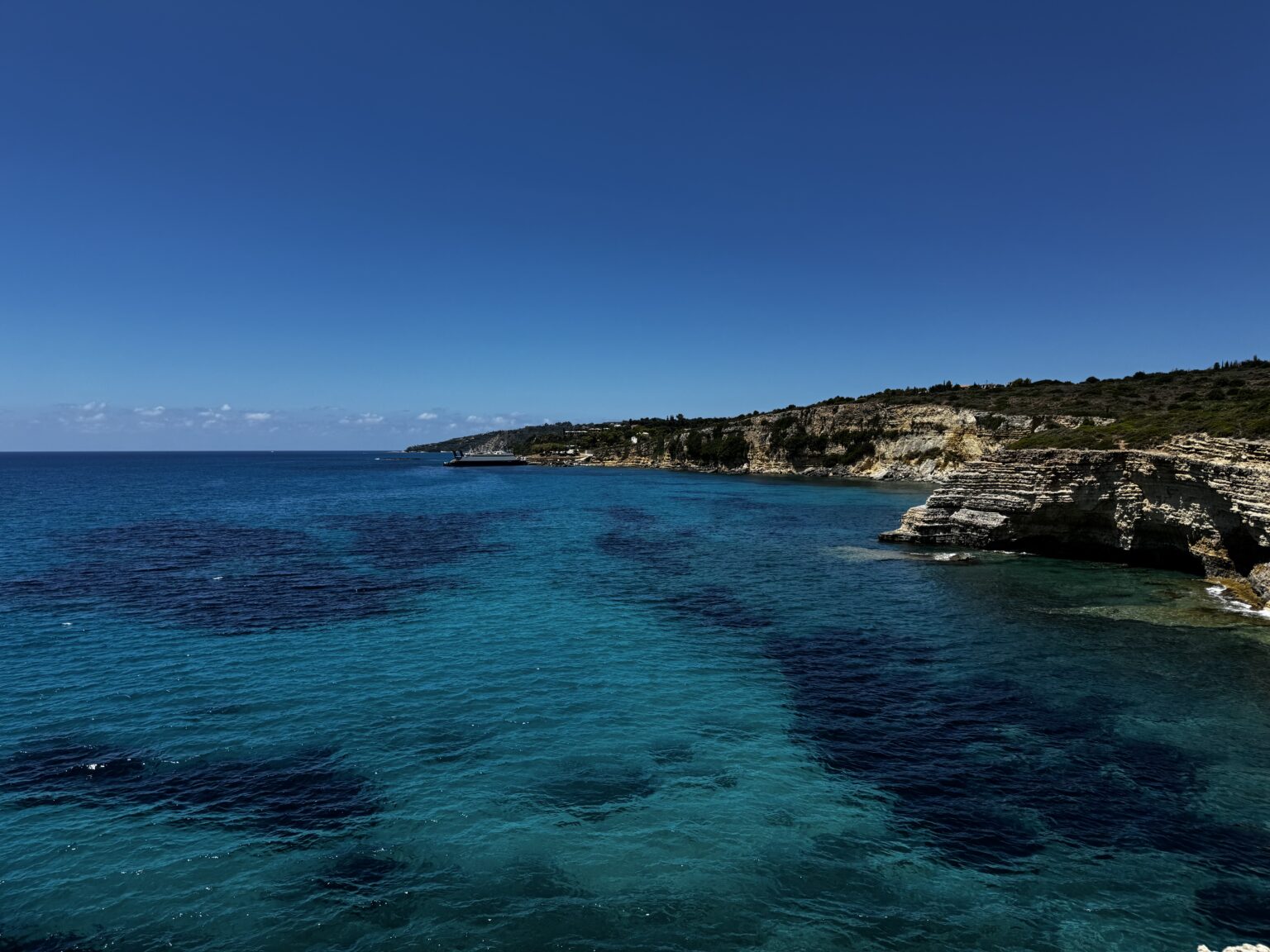 Turquoise cove and limestone cliffs along the Kefalonia coastline near Anemos Escape Villas